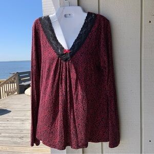 It’s red and black top has a Lovely lace V-neck with a little red bow. So soft!